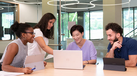 group of students around laptop